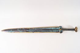 A reproduction Oriental bronze short sword with decoration to the blade,