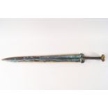 A reproduction Oriental bronze short sword with decoration to the blade,