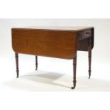 A 19th century mahogany Pembroke table with one drawer, raised on turned legs with brass casters,