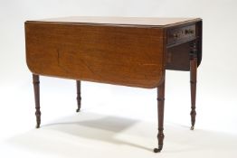 A 19th century mahogany Pembroke table with one drawer, raised on turned legs with brass casters,