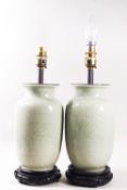 A pair of floral table lamps, 42cm high and a pair of celadon table lamps,