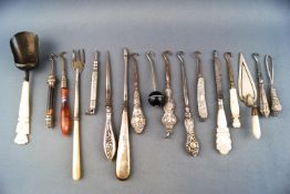 A selection of glove button hooks with silver agate and metal handles etc and a silver caddy spoon
