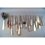 A selection of glove button hooks with silver agate and metal handles etc and a silver caddy spoon