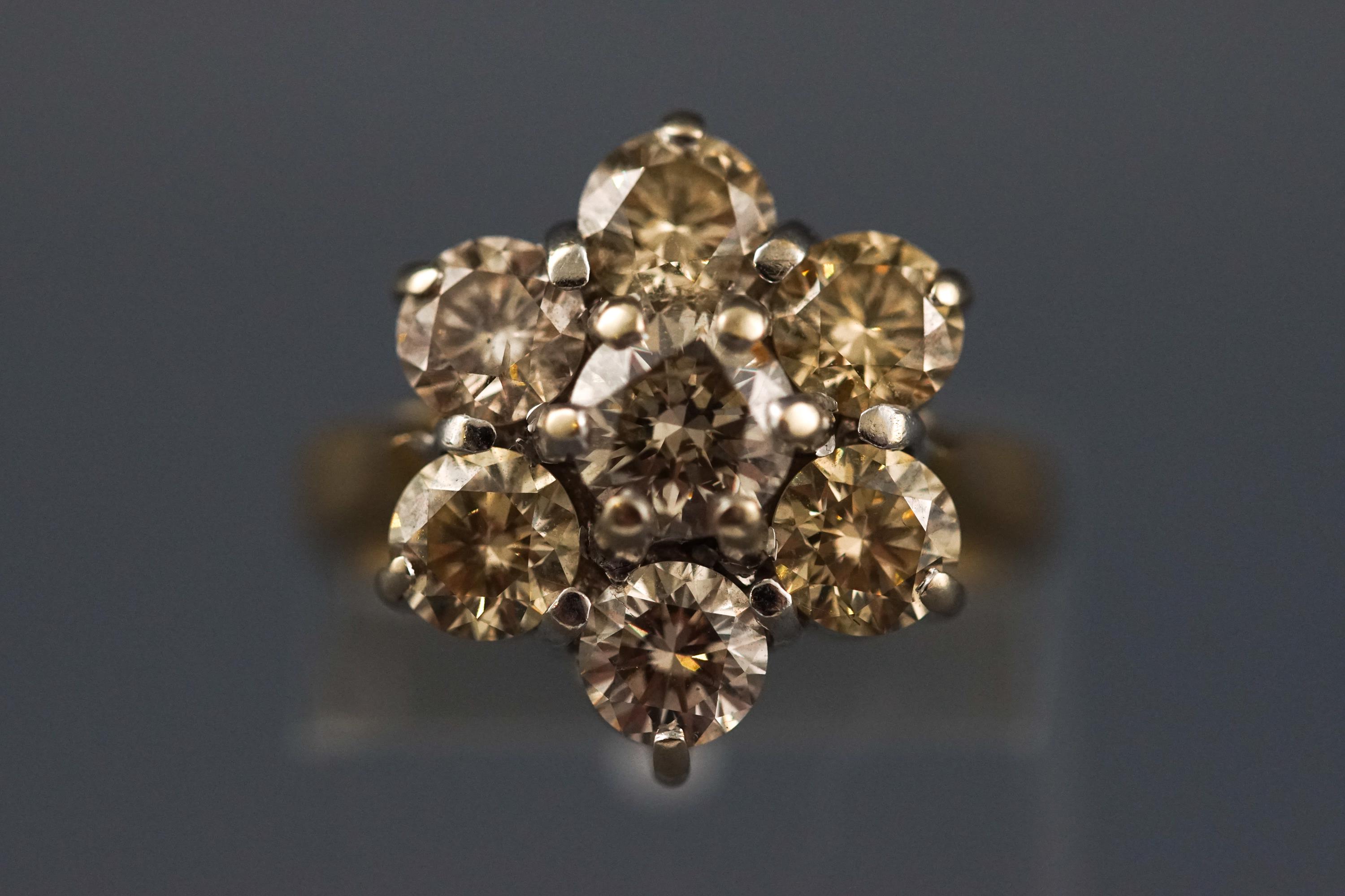 A yellow and white metal seven stone diamond flower ring, Estimated total weight of 2.50 carats. - Image 2 of 7