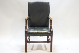 A George III style leather upholstered elbow chair with mahogany arm supports and square legs