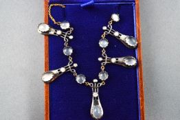 A necklace set with cabochon moonstones and diamonds suspended from a trace link chain (broken).