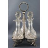 A silver trefoil cruet frame on three feet, suspended from a twisted rope work ringed finial handle,
