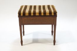 An Edwardian mahogany piano stool with satinwood cross banding on square tapering legs.....