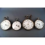 Four silver cased open face pocket watches and a winding key,