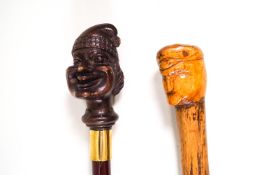 A prisoner of war stick of a man wearing a bonnet rouge and another walking stick,