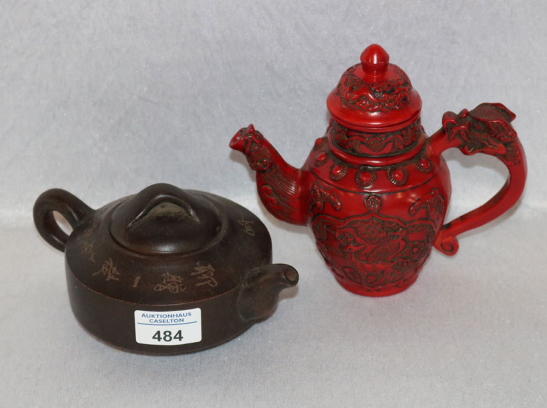 Rote Lackteekanne mit Reliefdekor, H 16 cm, B 19 cm, T 10 cm, und asiatische Keramik Teekanne mit