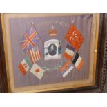 A framed WWI souvenir panel of Egypt with military photo to centre and flags.