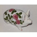 A Wemyss pottery pig painted in the clover pattern, 6.25” across – one ear re-stuck.