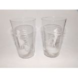 A pair of colourless Mary Gregory style beakers.