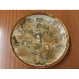 A Japanese Meiji period Satsuma earthenware lobed dish decorated numerous religious figures in