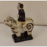 A small Chinese stoneware model of a lohan riding a tiger, Northern Song Dynasty (960-1127AD),