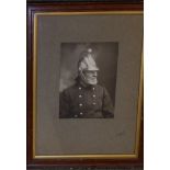 Two Victorian framed photographs of maidservants, a photograph of a fireman and two street