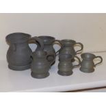 Six small pewter measures.