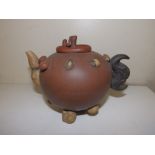 A Chinese brown stoneware teapot, the cover with mushroom finial, the handle formed as buffalo