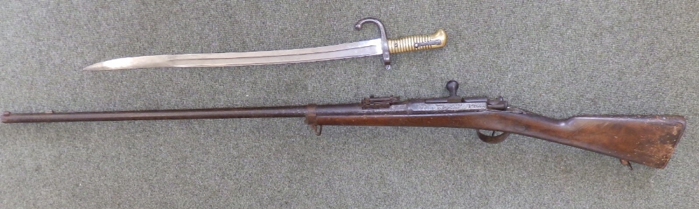 A French chassepot (woodwormed) together with a crurved bayonet.