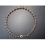 A graduated black opal bead necklace with pearl spacers having sapphire & diamond cluster clasp, 16”