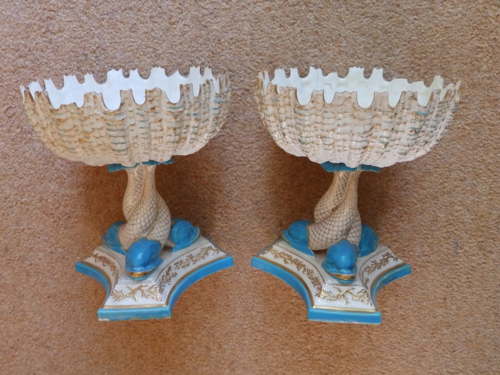 A pair of Royal Worcester dolphin pedestal bowls, 7.5” high – both damaged.