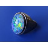 An opal effect signet ring in yellow metal – finger size S.