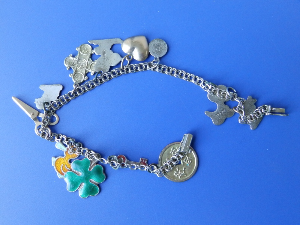 A small yellow metal charm bracelet set with base metal & gold charms.