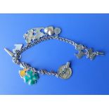 A small yellow metal charm bracelet set with base metal & gold charms.