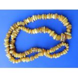 A long string of irregular amber beads, 34”.