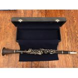 A cased mid-20thC rosewood clarinet by Cabart of Paris.