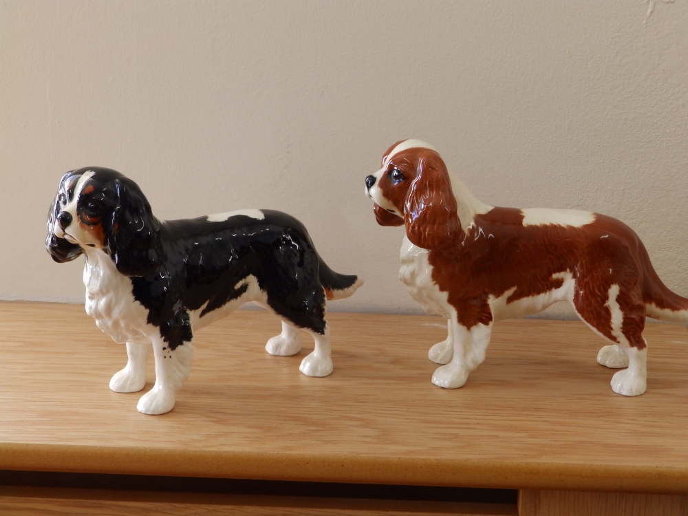 Two Beswick Cavalier King Charles Spaniels – tan and dark brown respectively.