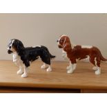 Two Beswick Cavalier King Charles Spaniels – tan and dark brown respectively.