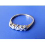 A five stone graduated diamond ring in yellow metal – finger size P.