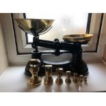A set of 20thC kitchen scales with brass weights.