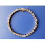 A diamond tennis bracelet, set with 36 brilliant cut stones of total weight in excess of 5 carats in