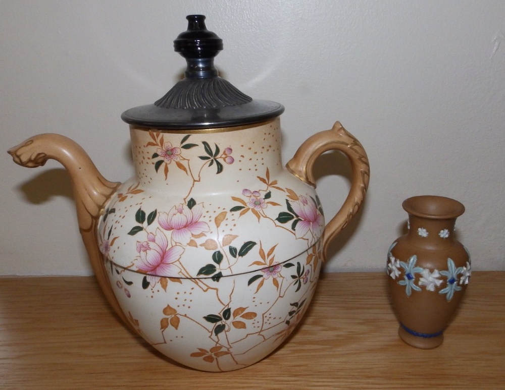 A Doulton Burslem Royles Patent self pouring teapot and a small Lambeth Silicon Ware vase. (2)