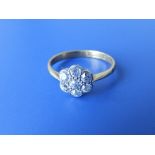 A small diamond daisy cluster 18ct gold ring. Finger size I.