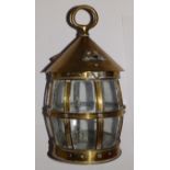 A circular brass barrel-shaped lantern with glazed base, 11” high.