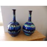 A pair of turquoise banded bottle vases – one with old paper label, 10.5”. (2)