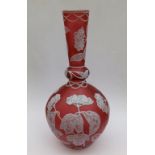 A late 19thC cameo glass vase in white on cranberry by Stevens & Williams, the tapering neck &