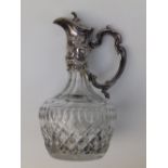 A cut glass claret jug with EP mounts.