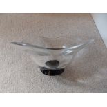 An Orrefors glass bowl with black foot, 7.5” diameter.