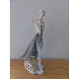 An elongated Capodimonte porcelain figure of a woodsman.