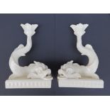 A pair of 20thC Wedgwood creamware dolphin candlesticks, 10”.