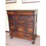 An early 18thC chest of drawers in two parts, having cushion moulded concealed frieze drawer over