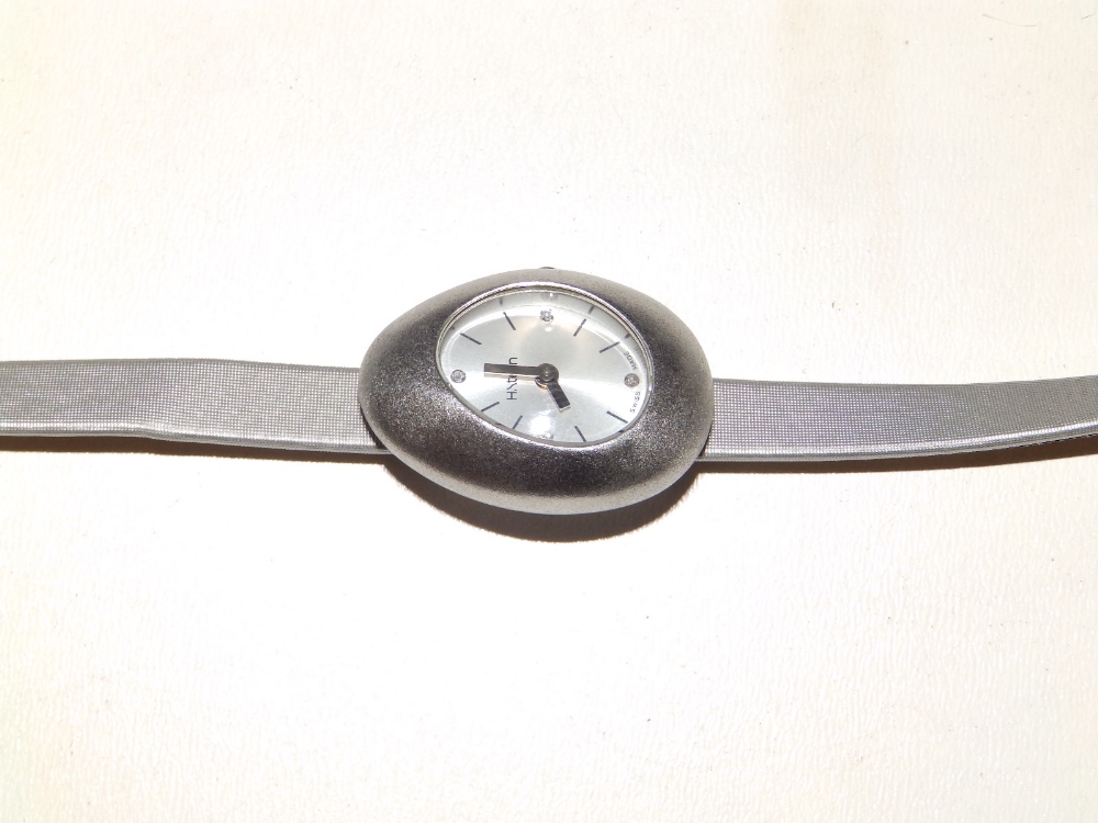 A stainless steel lady's wrist watch by H. Stern on long leather strap.