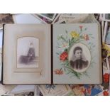 An early 20thC family photo album together with approximately 50 loose postcards and greeting