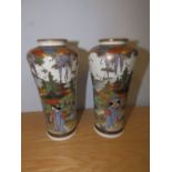 A pair of Japanese Satsuma vases decorated figures with Mount Fuji in the background, 7.5” high.