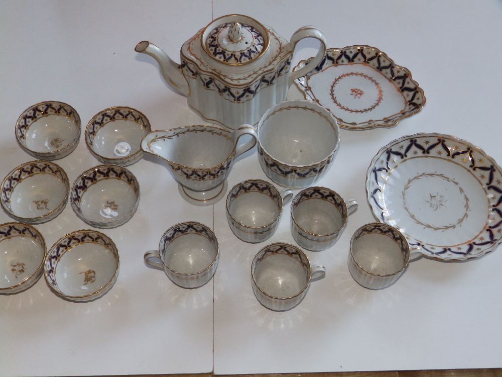 A 16 piece New Hall fluted porcelain tea set including teapot, decorated in dark blue & gold pattern